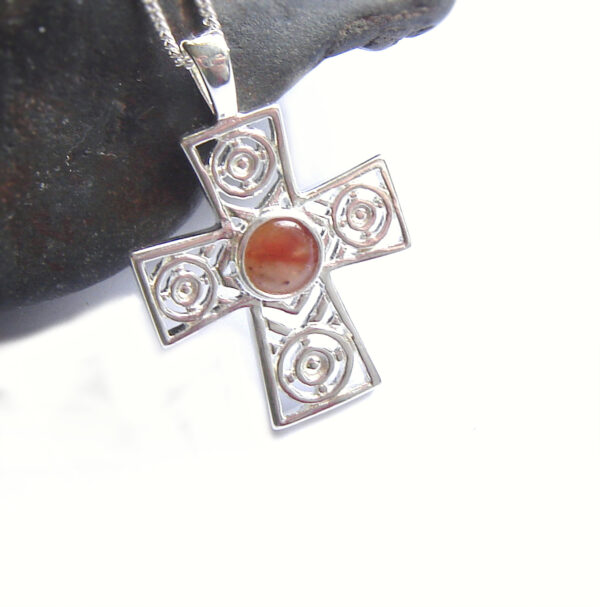 British Agate Gemstone Celtic Cross set with natural agate chalcedony gemstone that I have collected by hand on the Northumbrian coast of England. I have handcrafted the gemstone into a tiny round cabochon, to set in this Celtic sterling silver cross with a repeat circles design. Men'as and women's Gemstone Crosses by Northumbria Gems.