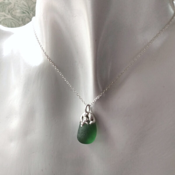 Coastal Inspired Green Seaglass Necklace. A nature-inspired necklace in authentic seaglass collected by hand on the Northumbrian coast of England. The sea glass is set in silver which I have handcrafted in an original design to resemble seaweed fronds. Men's and women's jewellery by Northumbria Gems.