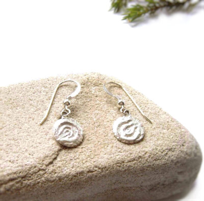 Cup and Ring Marks Silver Earrings. Small, round drop earrings with a textured finish inspired by Northumberland's prehistoric rock art, the broken concentric circles in the style of cup and ring marks.Individually handcrafted in the north-east of England, and hallmarked. By Northumbria Gems.