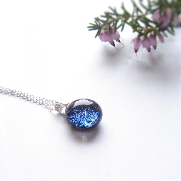Small round cobalt blue sparkling dichroic fused glass pendant.