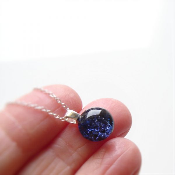 Small round cobalt blue sparkling dichroic fused glass pendant.
