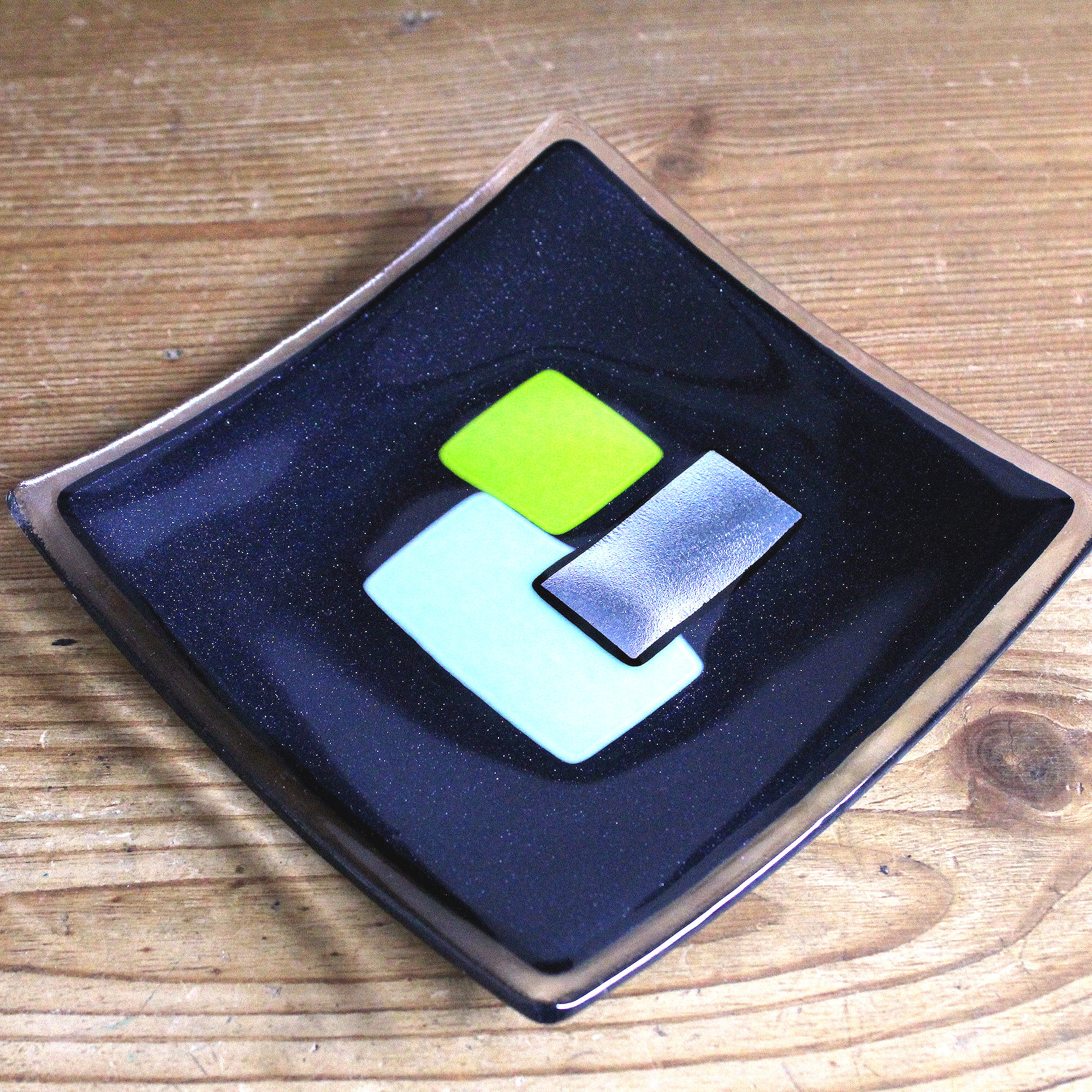 '60s retro geometric fused glass dish in mint and lime on black. Handmade by Northumbria Gems.
