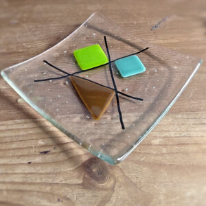 Handmade geometric fused glass dish in 60s retro colours. Dish with lime and tan accents, by Northumbria Gems.