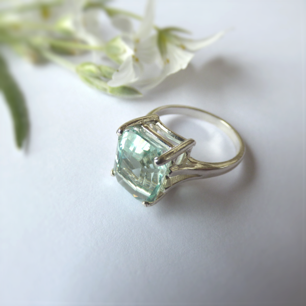 A unique ring handcrafted with aqua blue sea glass, set in a contemporary silver ring with a 4 prong setting. Size M1/2 UK