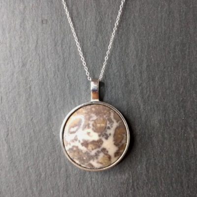 Large round silver pendant with handcrafted natural jasper agate from the Northumberland coast. The stone has unusual brown, ochre and cream markings and is one-of-a-kind.