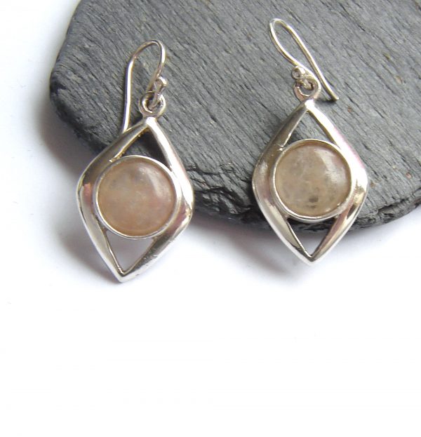 Natural British Carnelian Drop Earrings. Contemporary style large cabochon earrings in pale carnelian quartz, a natural, semi-precious gemstone collected by hand on the lovely Northumbrian coast, northern England. Using lapidary techniques, I have shaped the gemstone into round cabochons and set these in sterling silver drop earrings. Natural Gemstone Earrings by Northumbria Gems.