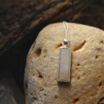 Natural White Quartz Oblong Necklace. British Quartz Pendant in Sterling Silver. This quartz has been hand-collected on the Northumbrian coast of England, then hand cut into an oblong cabochon with a bevelled edge and set in sterling silver. Quartz Jewellery from Northumbria Gems, United Kingdom.