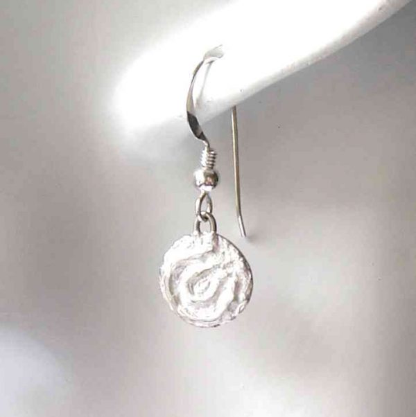 Cup and Ring Marks Silver Earrings. Small, round drop earrings with a textured finish inspired by Northumberland's prehistoric rock art, the broken concentric circles in the style of cup and ring marks.Individually handcrafted in the north-east of England, and hallmarked. By Northumbria Gems.