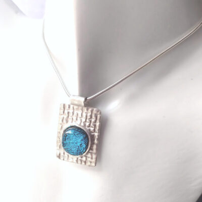 Silver Weave Dichroic Blue Pendant large rectangle pendant handmade in textured silver with a blue dichroic fused glass cabochon. Made in England.