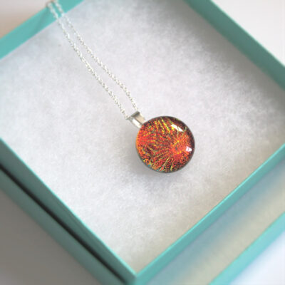 Sunburst Orange Dichroic Pendant handmade in flame-coloured, textured dichroic fused glass, in sterling silver. Elements inspired necklace handmade in Northumbria, England.