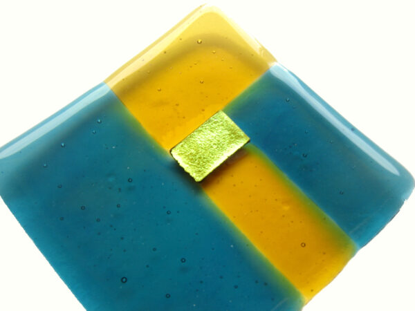 Teal and Amber Small Fused Glass Dish. Square dish in a geometric design of teal, dark amber and dichroic gold glass. Ring or trinket dish handmade in England