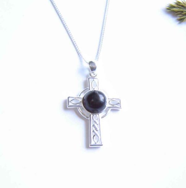 Whitby Jet Celtic Cross Necklace. A Celtic cross necklace in natural black Whitby jet from the North Yorkshire, England (historically in Northumbria). I have handmade the jet into a small, round cabochon, then set it in this sterling silver Celtic cross.