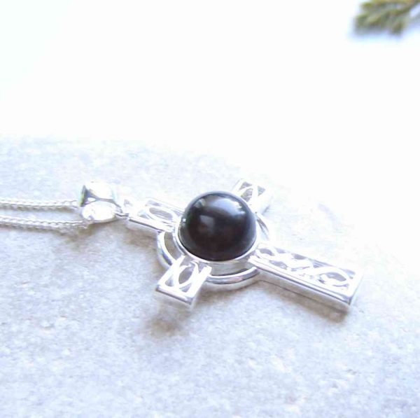 Whitby Jet Celtic Cross Necklace. A Celtic cross necklace in natural black Whitby jet from the North Yorkshire, England (historically in Northumbria). I have handmade the jet into a small, round cabochon, then set it in this sterling silver Celtic cross.