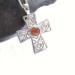 British Agate Gemstone Celtic Cross set with natural agate chalcedony gemstone that I have collected by hand on the Northumbrian coast of England. I have handcrafted the gemstone into a tiny round cabochon, to set in this Celtic sterling silver cross with a repeat circles design. Men'as and women's Gemstone Crosses by Northumbria Gems.