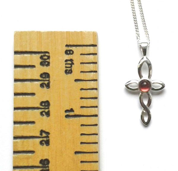 Small Celtic cross pendant set with a handcrafted tiny red garnet gemstone cabochon. Twist design cross necklace.