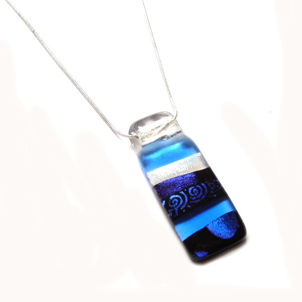 Blues and Swirls Layered Dichroic Pendant. A large, abstract statement pendant handmade in alternating plain and patterned dichroic fused glass, the colours varying in different lights. Made in England.